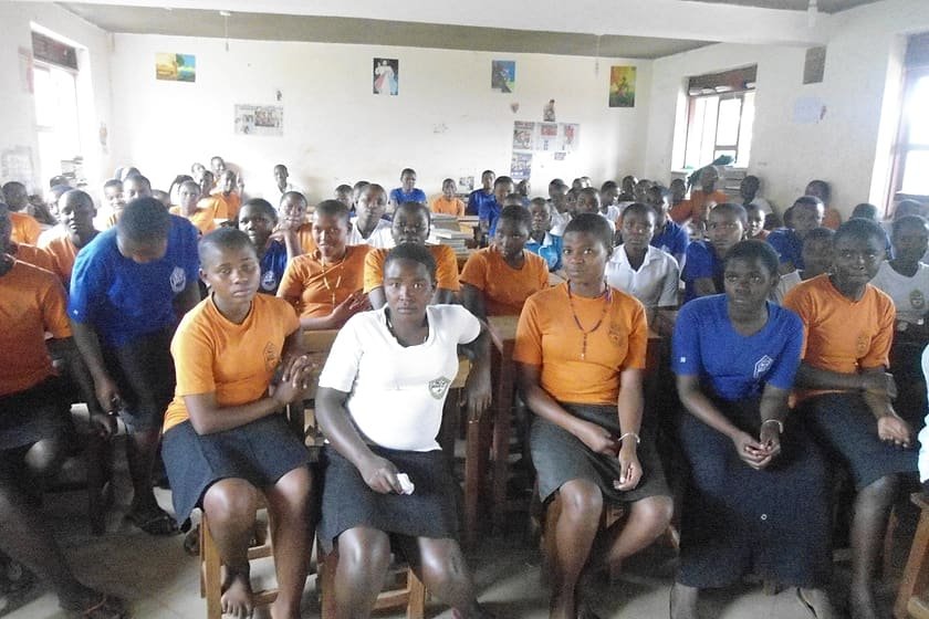 Secondary school students seated together during a Kiyunga Social Service Centre school outreach session.